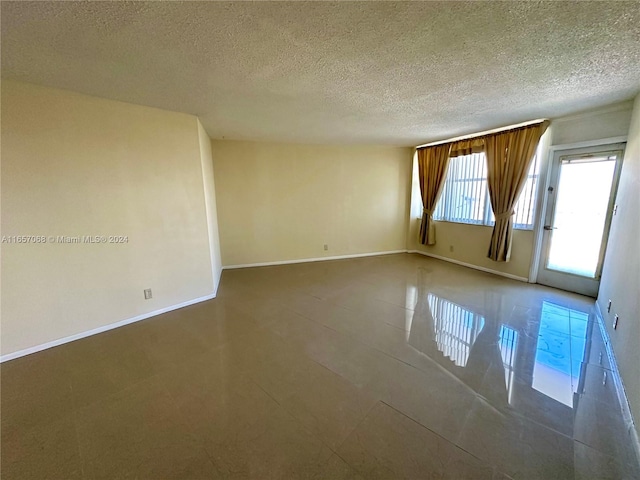 empty room featuring a textured ceiling