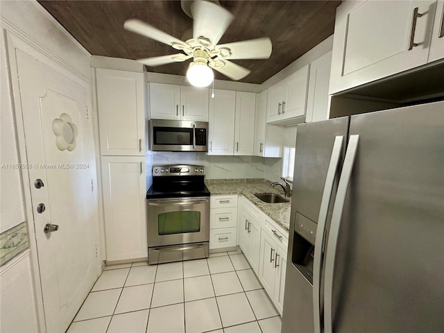 kitchen featuring white cabinets, sink, ceiling fan, appliances with stainless steel finishes, and light stone counters