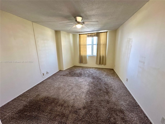 empty room featuring carpet, a textured ceiling, and ceiling fan