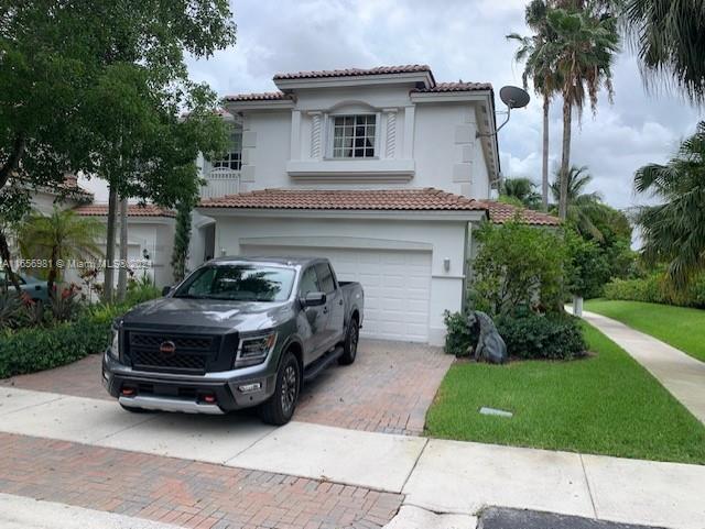 mediterranean / spanish home featuring a garage