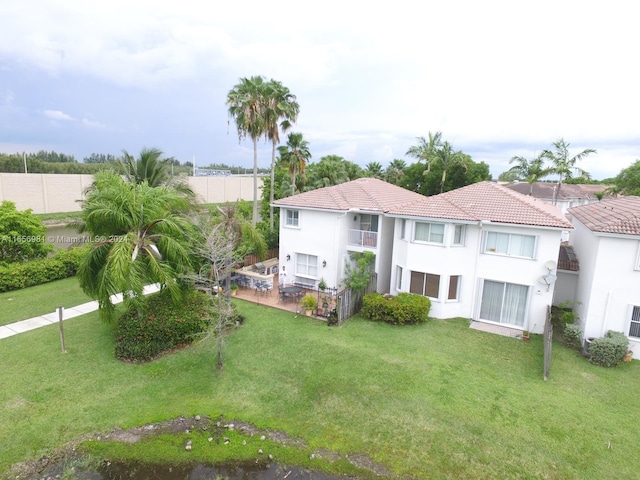 back of house with a lawn