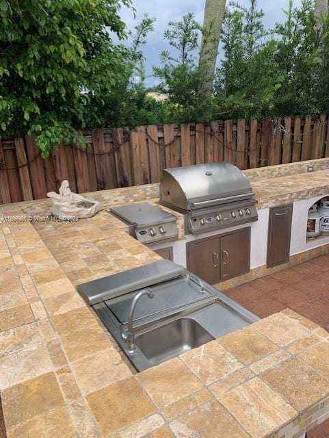 view of patio featuring area for grilling, grilling area, and sink