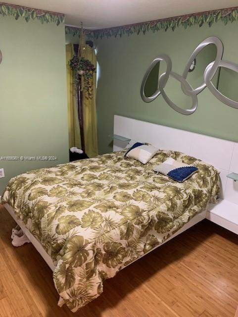 bedroom featuring wood-type flooring