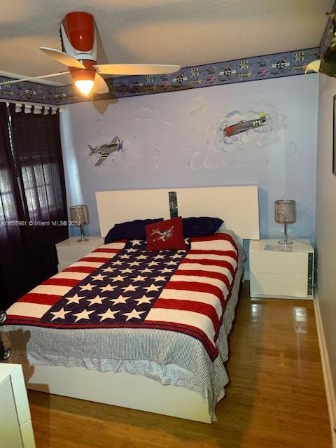 bedroom featuring ceiling fan and hardwood / wood-style flooring