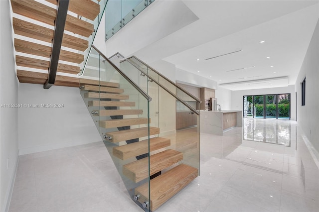 staircase featuring tile patterned floors