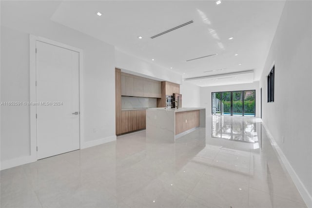 kitchen with a kitchen island with sink