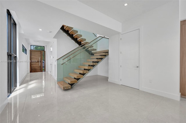 staircase with recessed lighting and baseboards