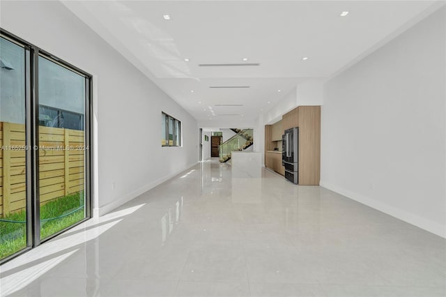 hall with light tile patterned flooring