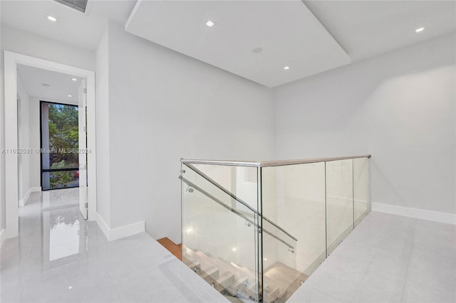 hallway featuring recessed lighting and baseboards