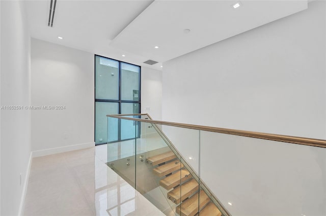 stairway with floor to ceiling windows