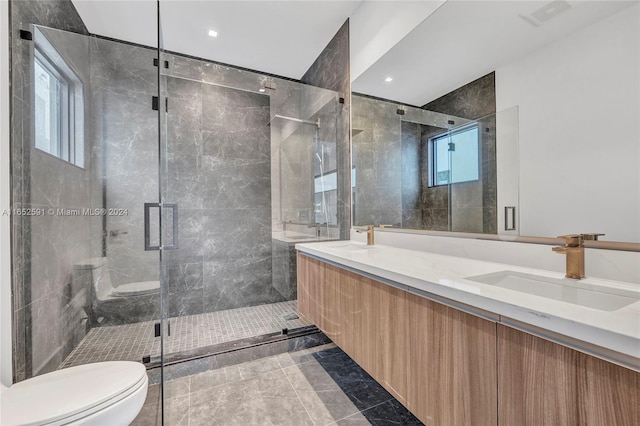 full bathroom with double vanity, toilet, a shower stall, and a sink