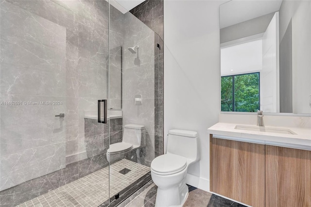 bathroom featuring baseboards, toilet, a shower stall, and vanity