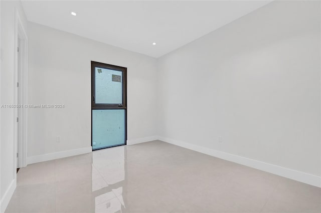 empty room with recessed lighting, baseboards, and light tile patterned flooring