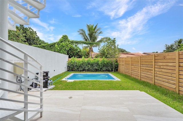 view of pool with a lawn, a patio, a fenced backyard, and a fenced in pool