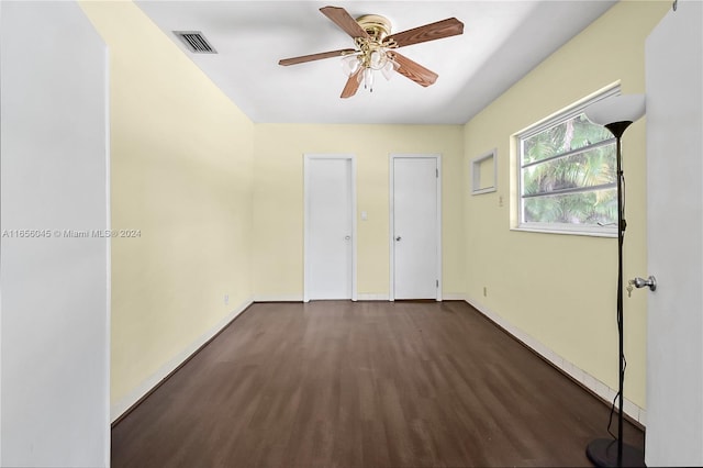 spare room with dark hardwood / wood-style floors and ceiling fan