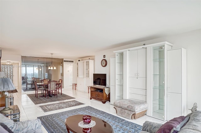 tiled living room with a notable chandelier