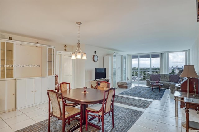 dining area with light tile patterned floors and a wall of windows