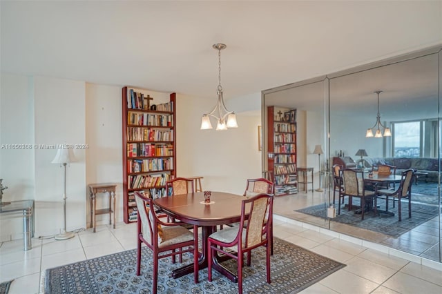 tiled dining room featuring an inviting chandelier