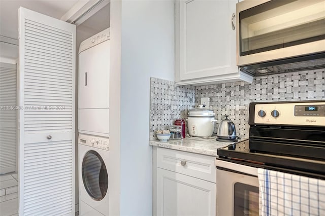 laundry room featuring stacked washer and clothes dryer