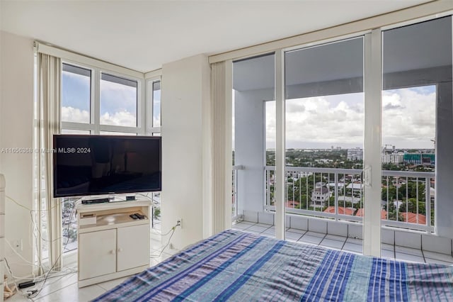 bedroom with multiple windows and light tile patterned floors