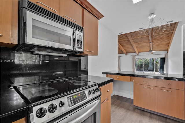 kitchen featuring wood ceiling, stainless steel appliances, lofted ceiling with beams, and backsplash