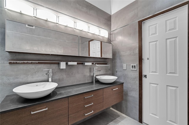 bathroom featuring tile walls, tile patterned flooring, and vanity