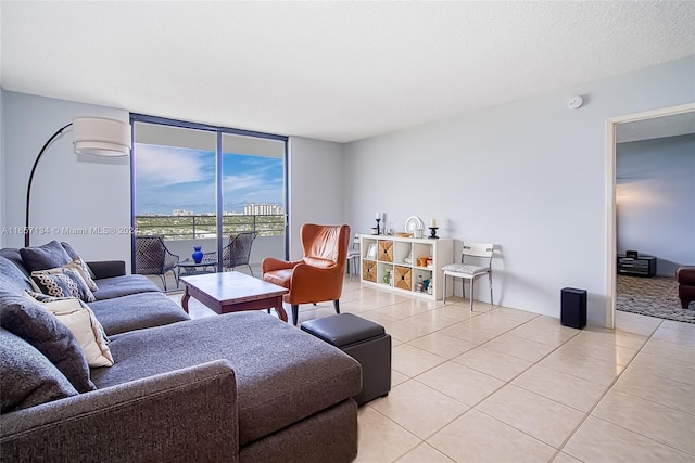 tiled living room featuring floor to ceiling windows