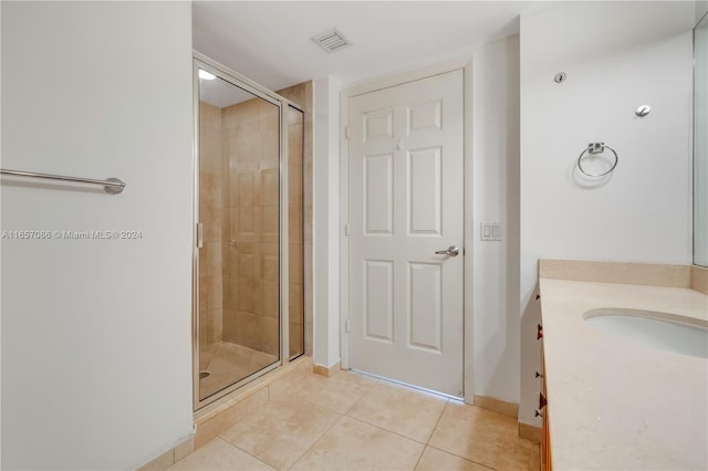 bathroom with vanity, tile patterned floors, and walk in shower