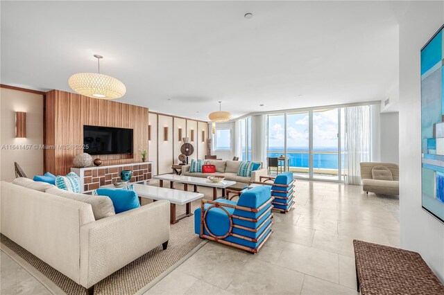 living room featuring a water view and light colored carpet