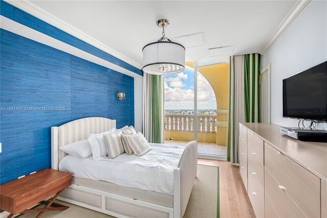 bedroom with access to exterior, light wood-type flooring, ornamental molding, and a chandelier