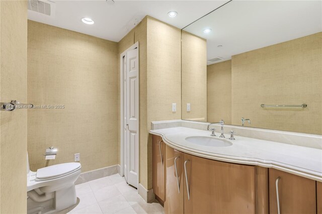 bathroom featuring tile patterned flooring, vanity, and toilet