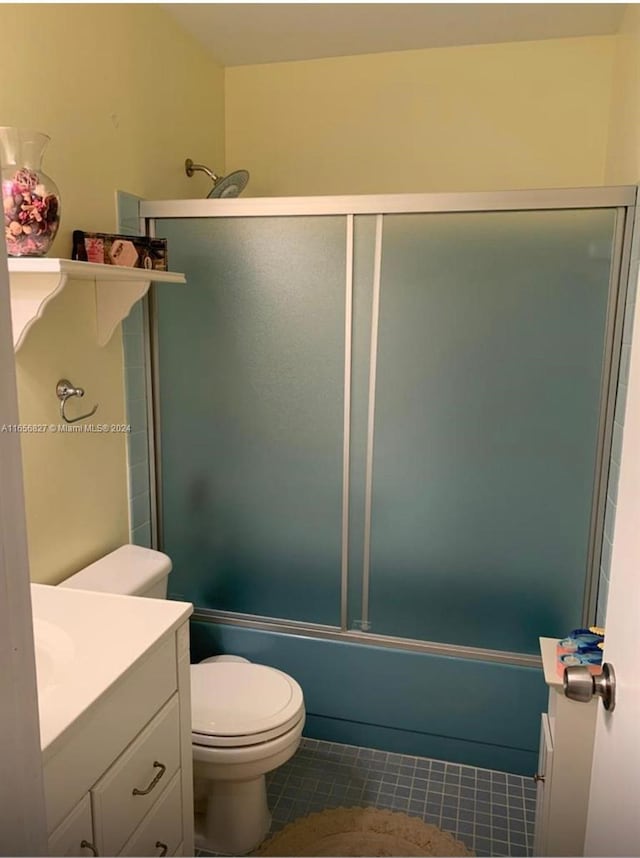 bathroom featuring tile patterned flooring, toilet, and vanity