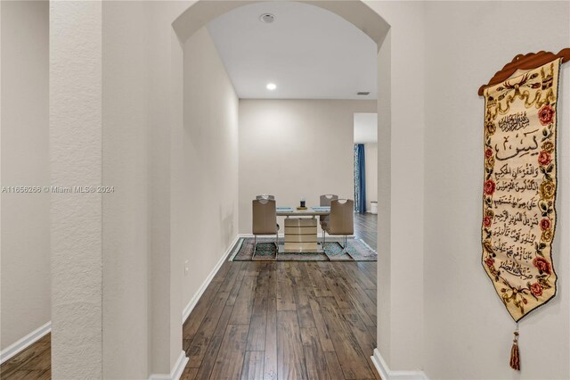 corridor with dark hardwood / wood-style flooring