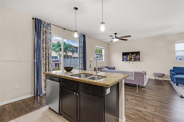 kitchen featuring pendant lighting, stainless steel dishwasher, sink, ceiling fan, and light wood-type flooring