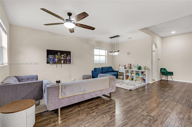 living room featuring ceiling fan and dark hardwood / wood-style flooring