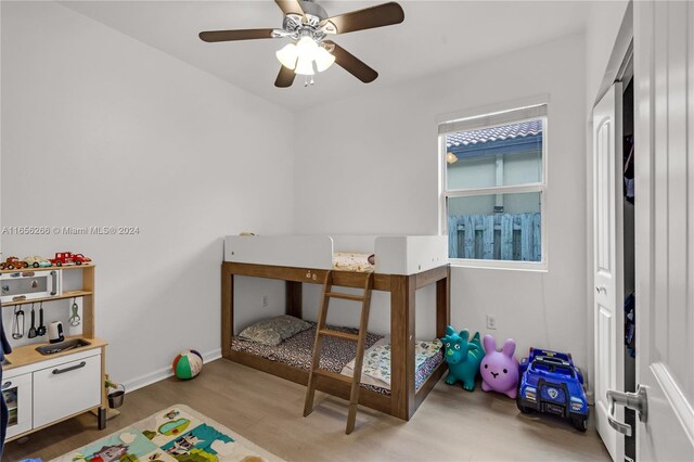 bedroom with ceiling fan and light wood-type flooring