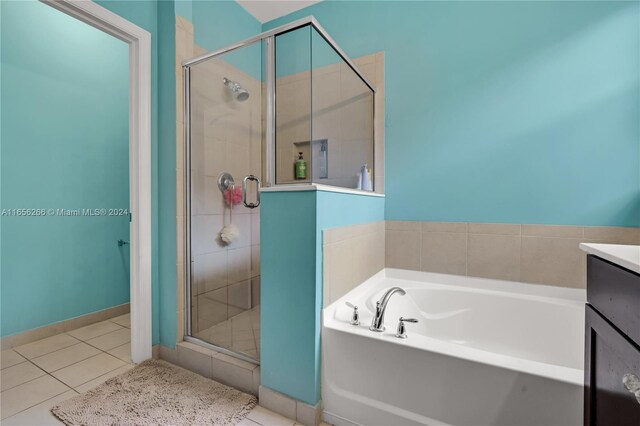 bathroom featuring vanity, tile patterned floors, and shower with separate bathtub