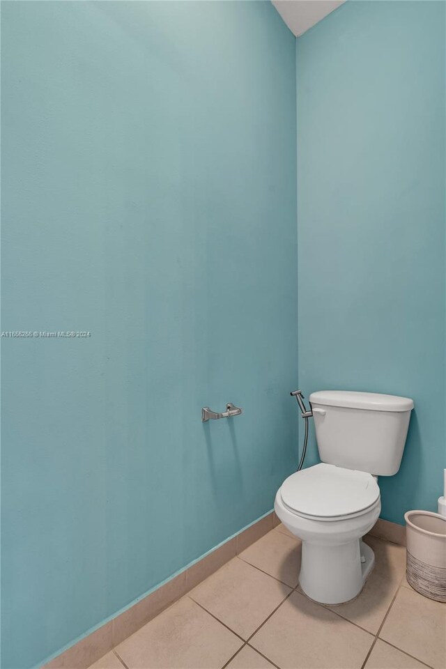 bathroom with tile patterned flooring and toilet