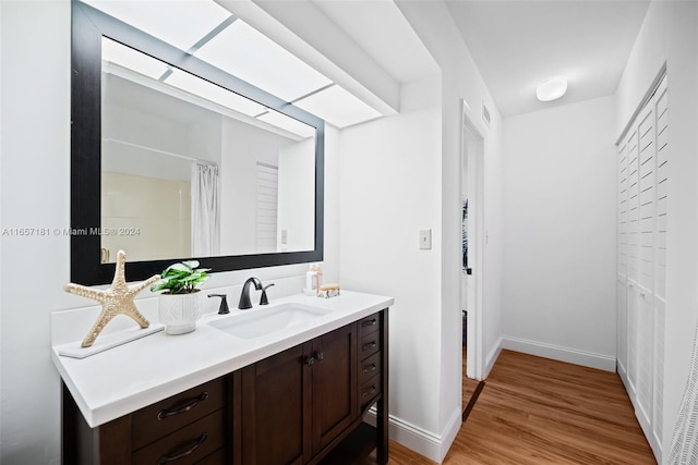 bathroom featuring vanity and hardwood / wood-style floors