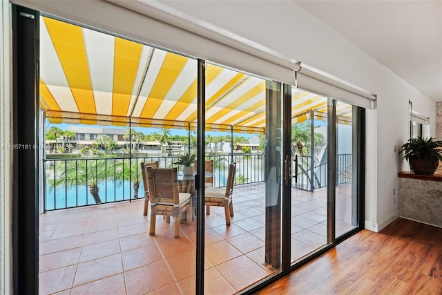 doorway featuring a water view and hardwood / wood-style flooring