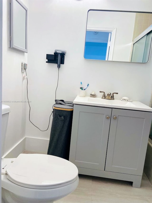 bathroom featuring vanity, toilet, a shower, and wood-type flooring