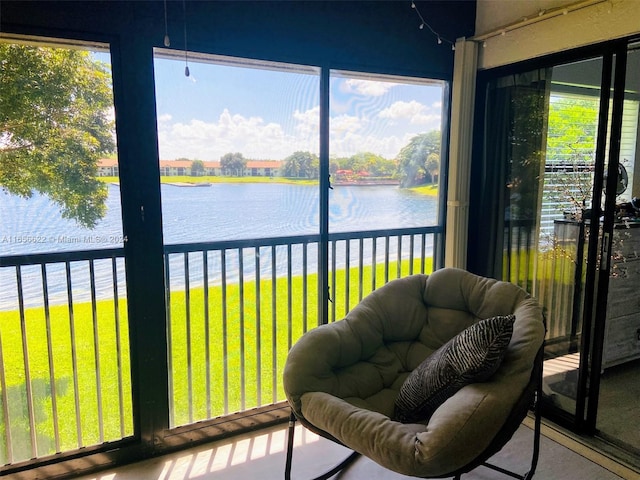 sunroom with a wealth of natural light and a water view