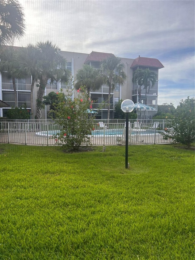 view of yard featuring a community pool