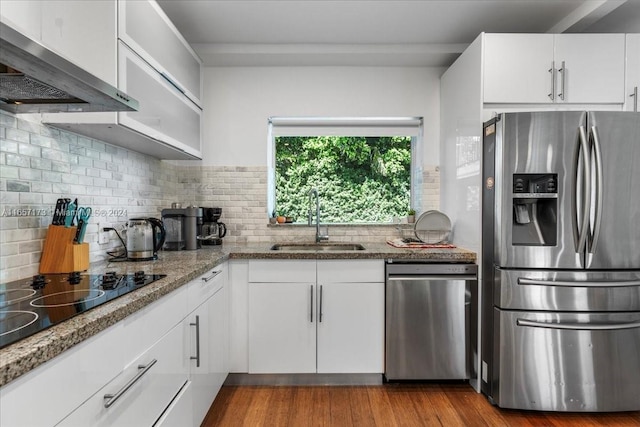 kitchen with light wood-type flooring, extractor fan, sink, appliances with stainless steel finishes, and white cabinets