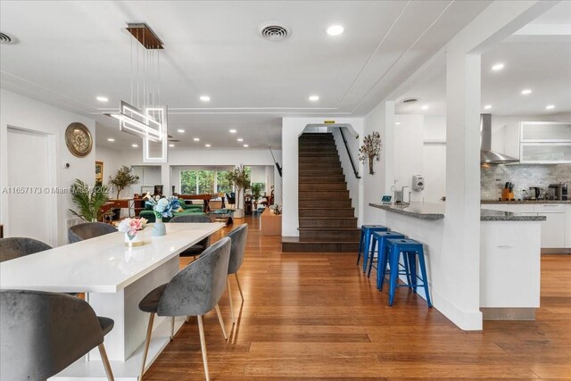 dining space featuring an inviting chandelier and light hardwood / wood-style flooring