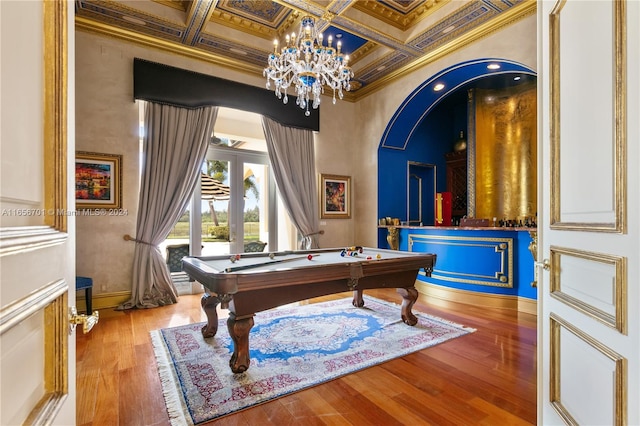 recreation room with coffered ceiling, beamed ceiling, ornamental molding, pool table, and wood-type flooring