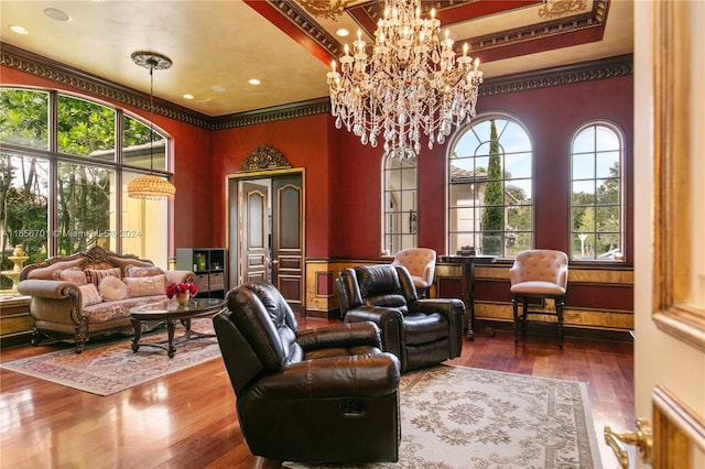 interior space featuring ornamental molding, hardwood / wood-style flooring, and a chandelier