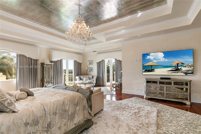 bedroom featuring a tray ceiling, crown molding, a chandelier, and dark hardwood / wood-style floors