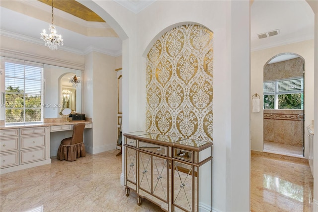 interior space featuring a chandelier, crown molding, and vanity