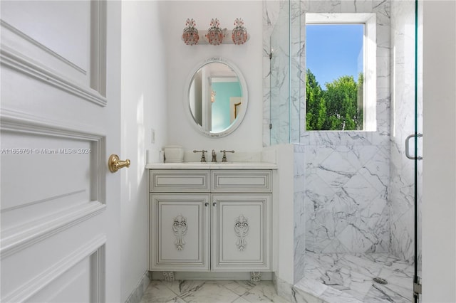 bathroom featuring a shower with door and vanity